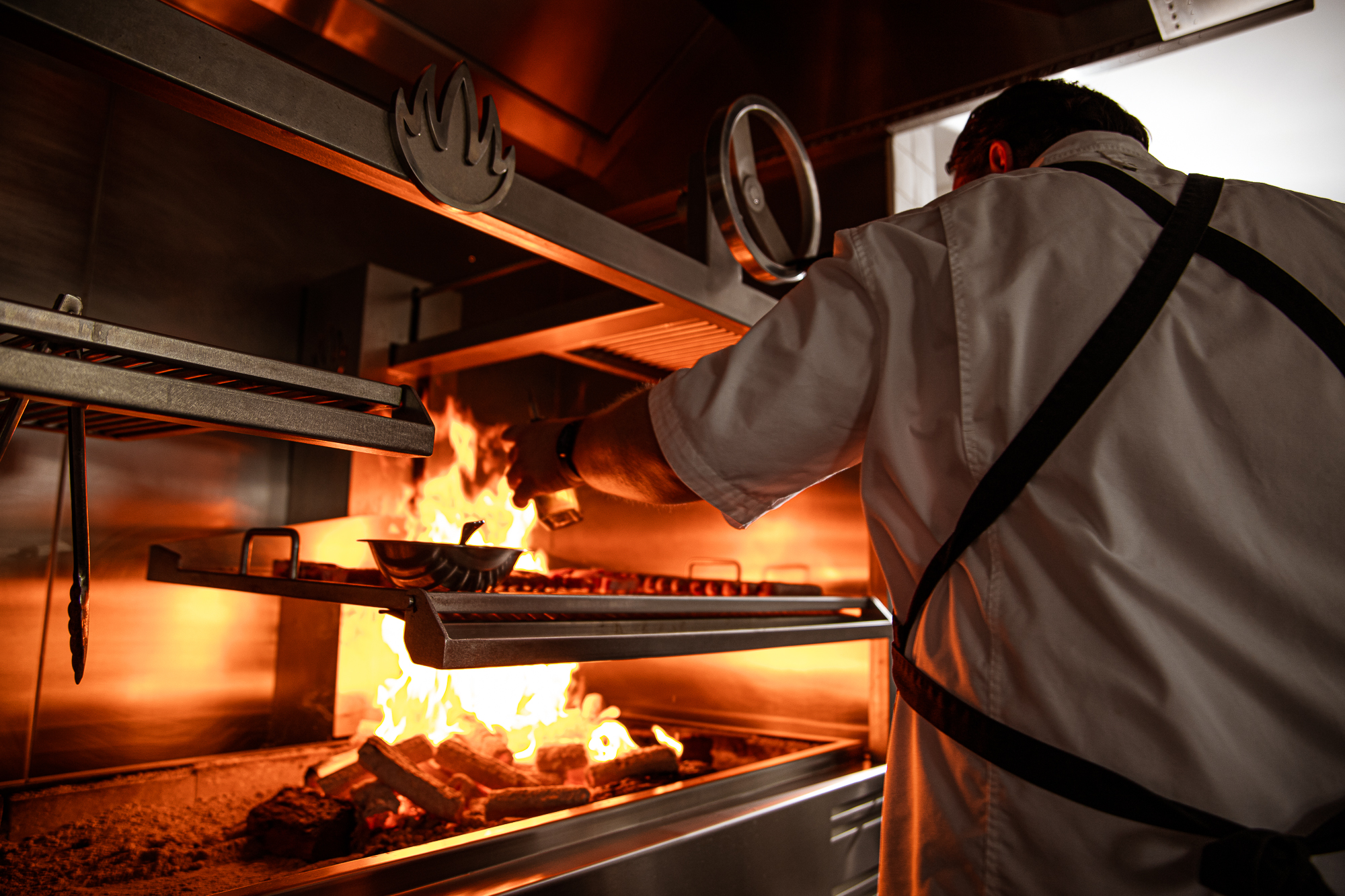 Chef cooking at fire grill